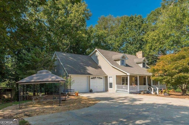 cape cod house with a garage, a porch, and a gazebo