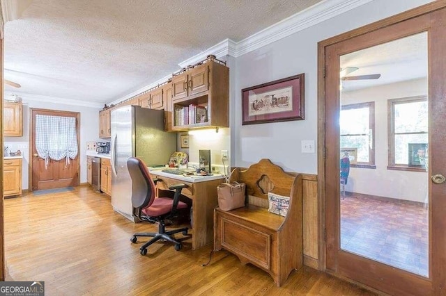 home office with crown molding, a textured ceiling, and light hardwood / wood-style floors