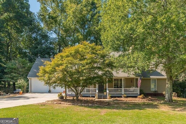 view of property hidden behind natural elements featuring a porch and a front yard