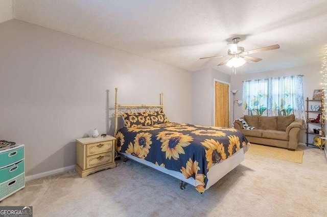 carpeted bedroom with vaulted ceiling and ceiling fan