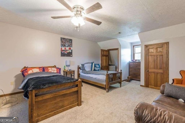 carpeted bedroom featuring ceiling fan, vaulted ceiling, and a textured ceiling