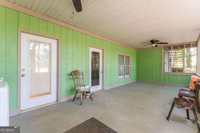 sunroom / solarium featuring ceiling fan