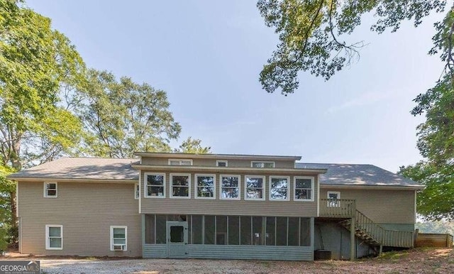 back of property with a sunroom