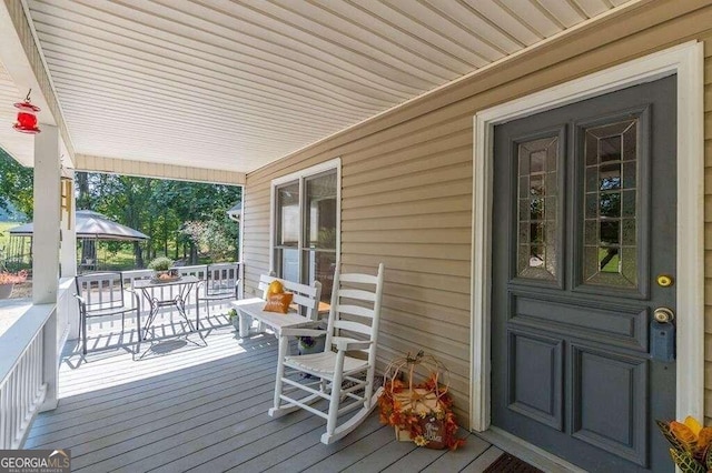 wooden terrace with a porch