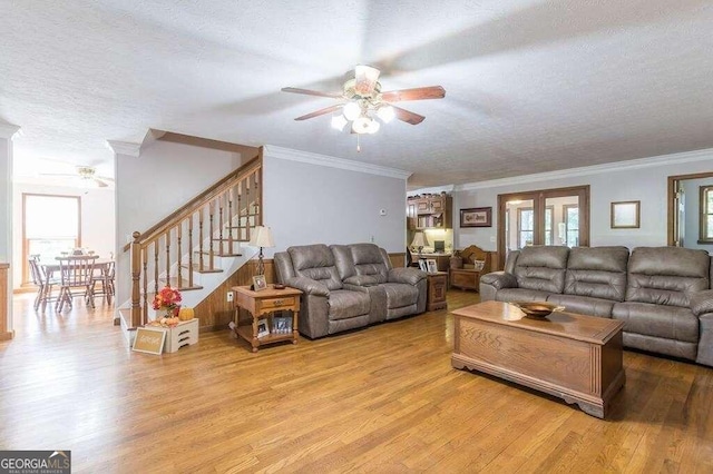 living room featuring plenty of natural light, light hardwood / wood-style floors, and a textured ceiling