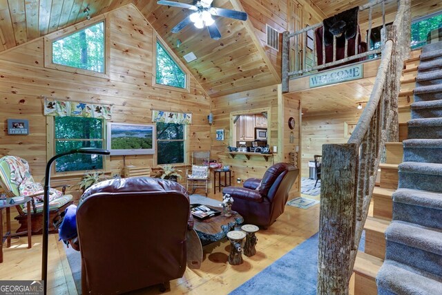 living room featuring high vaulted ceiling, ceiling fan, and wooden ceiling