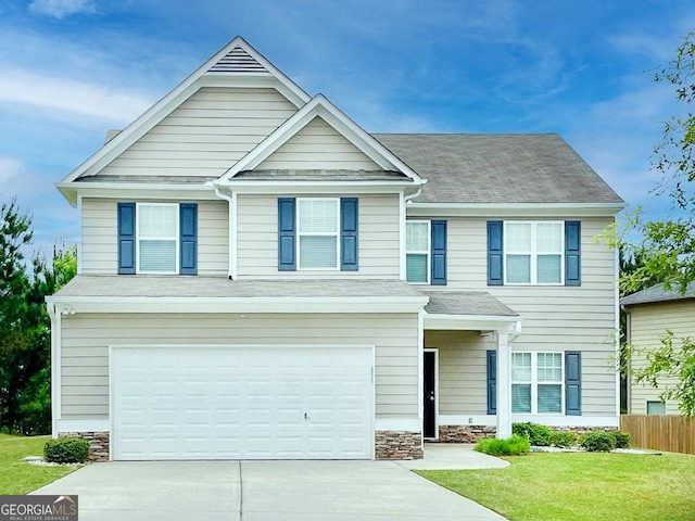 view of front of house with a garage and a front lawn