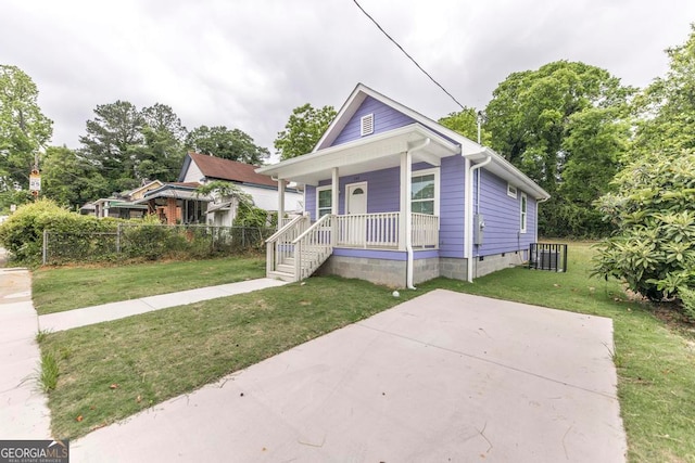 bungalow-style house with covered porch and a front lawn