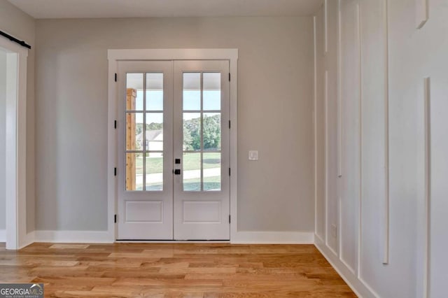 doorway featuring light hardwood / wood-style flooring and french doors