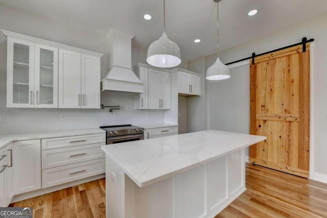 kitchen featuring white cabinetry, custom exhaust hood, pendant lighting, and electric range