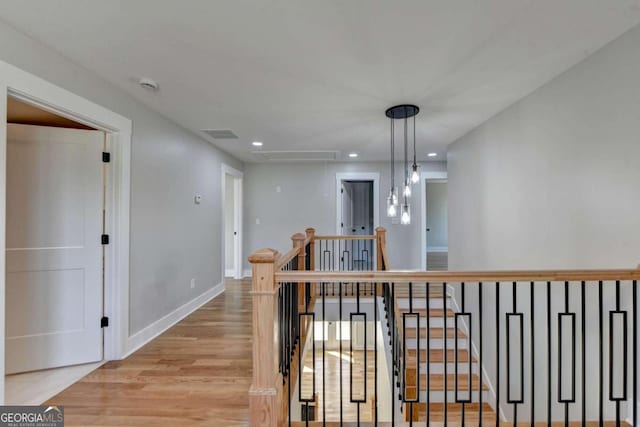 corridor with light hardwood / wood-style flooring