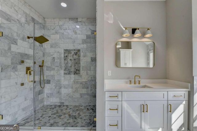 bathroom with walk in shower and vanity