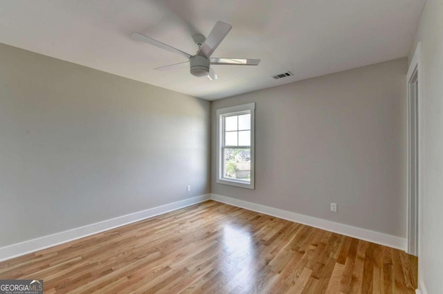 spare room with light wood-type flooring and ceiling fan