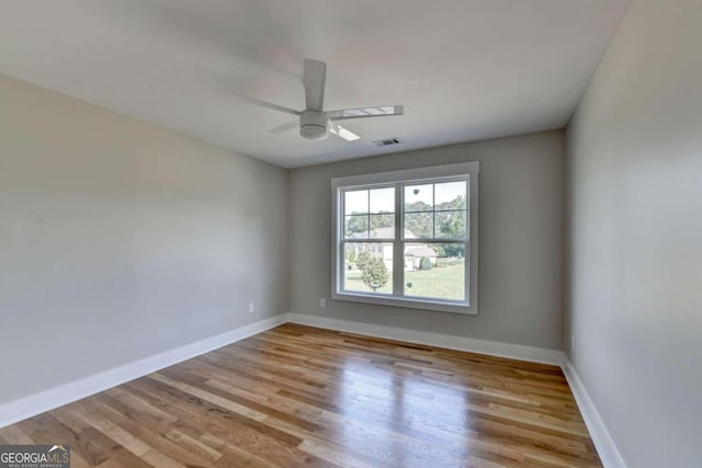 spare room with ceiling fan and light wood-type flooring