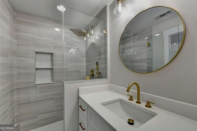 bathroom featuring vanity and a tile shower