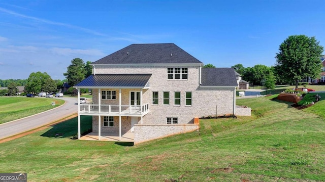 back of property featuring a patio and a lawn