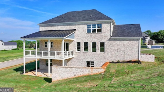 back of house featuring a lawn and a patio