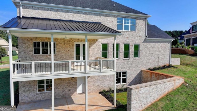 rear view of house with a yard and a patio area