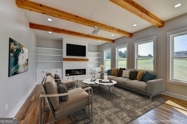 living room with beamed ceiling, wood-type flooring, and built in features