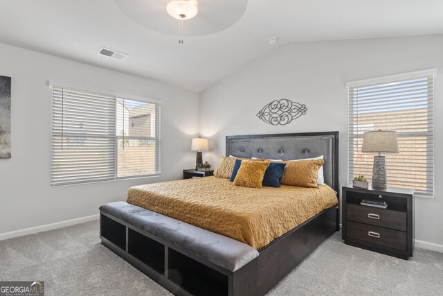 carpeted bedroom featuring multiple windows, ceiling fan, and lofted ceiling