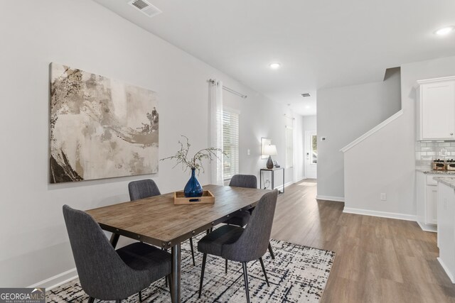 dining space with light hardwood / wood-style floors