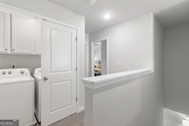 laundry room featuring cabinets and washing machine and dryer