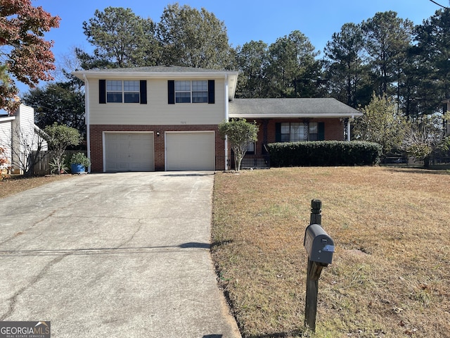 tri-level home featuring a garage and a front lawn