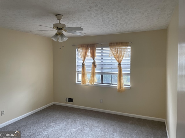 spare room featuring carpet, a textured ceiling, and ceiling fan