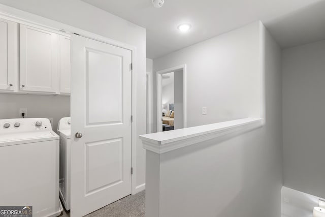 washroom with washer and clothes dryer, light colored carpet, and cabinets