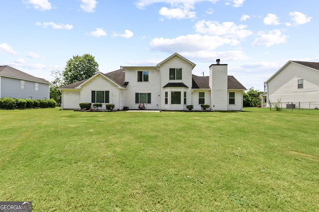 back of house featuring a lawn