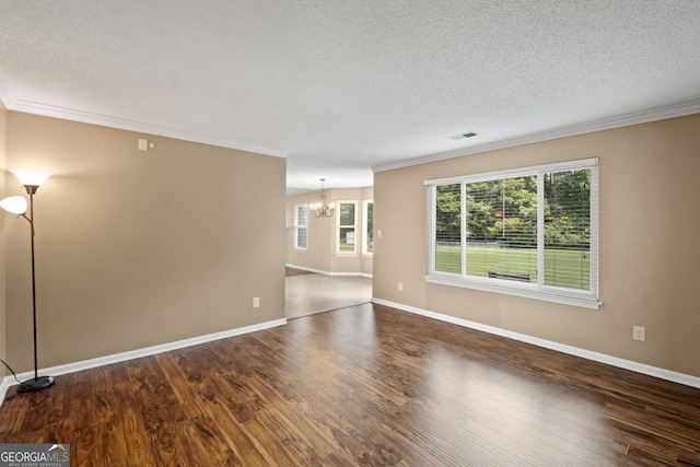 spare room featuring crown molding, a notable chandelier, a textured ceiling, and hardwood / wood-style floors