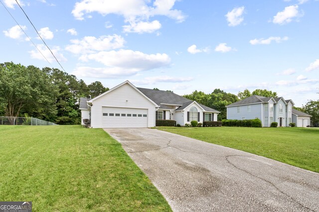 ranch-style home with a garage and a front lawn