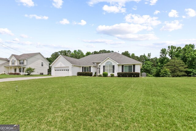 ranch-style house featuring a front lawn and a garage