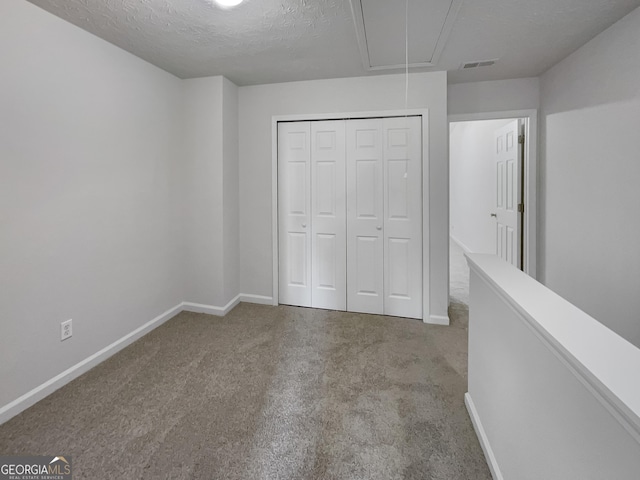 6531 Arbor Gate Dr SW # 12, Mableton, GA 30126 - unfurnished bedroom featuring light carpet, a closet, and a textured ceiling