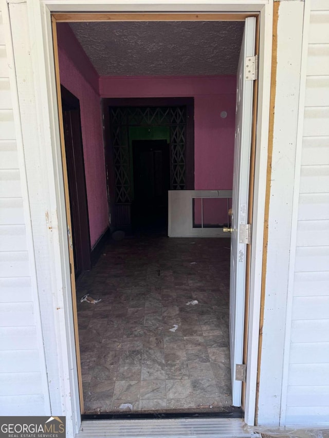 interior space featuring dark tile flooring