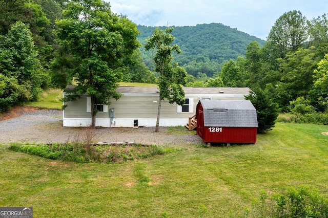 exterior space featuring an outdoor structure and a front yard