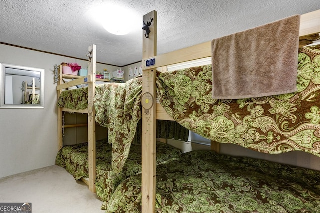 carpeted bedroom featuring a textured ceiling