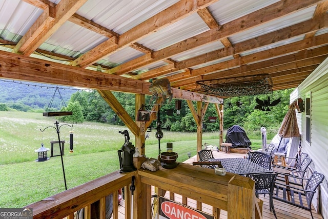 wooden terrace with a yard