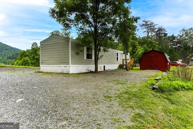 view of property exterior with a storage shed