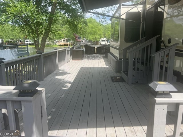 wooden deck featuring a water view