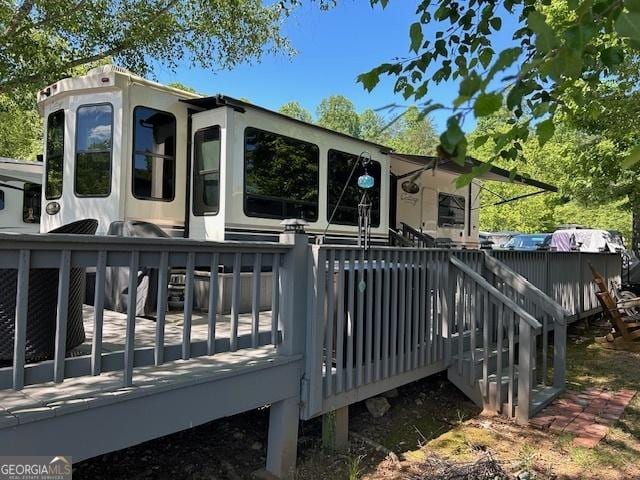 rear view of property with a wooden deck