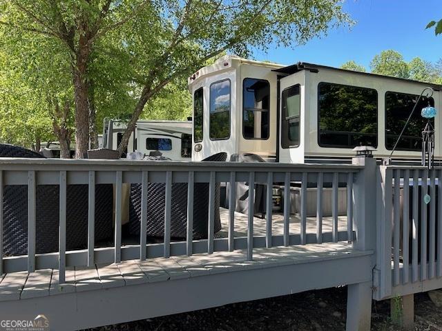 view of gate featuring a wooden deck