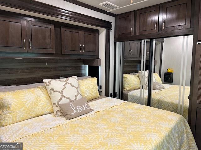 bedroom with ornamental molding and a closet