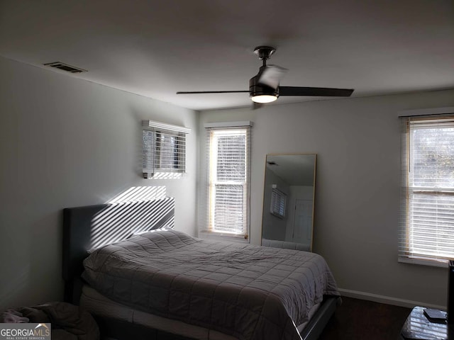 bedroom featuring ceiling fan and multiple windows