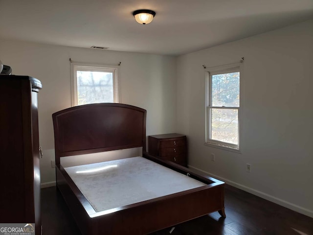 unfurnished bedroom featuring dark wood-type flooring