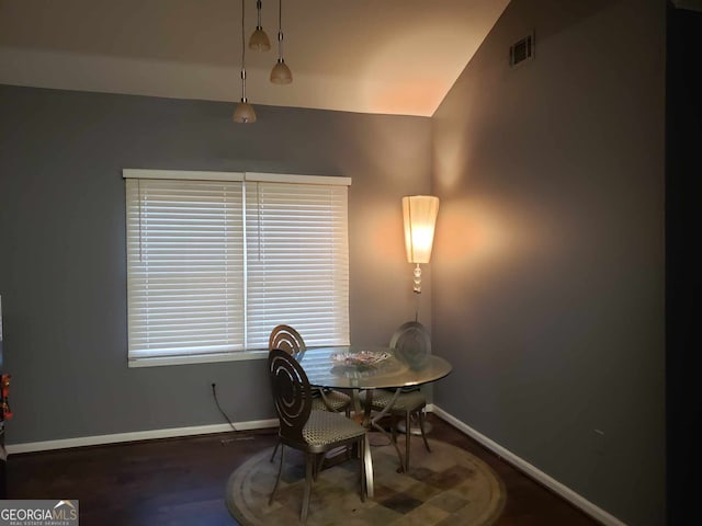 dining room featuring dark hardwood / wood-style floors and lofted ceiling