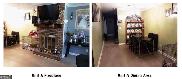 living room with ornamental molding, brick wall, wood-type flooring, and a fireplace