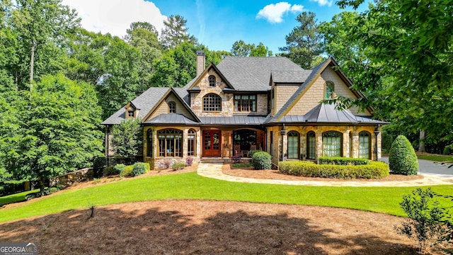 view of front of house with a front yard and a porch