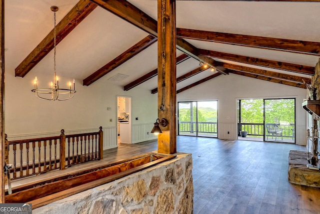 living room with hardwood / wood-style floors, lofted ceiling with beams, and a chandelier