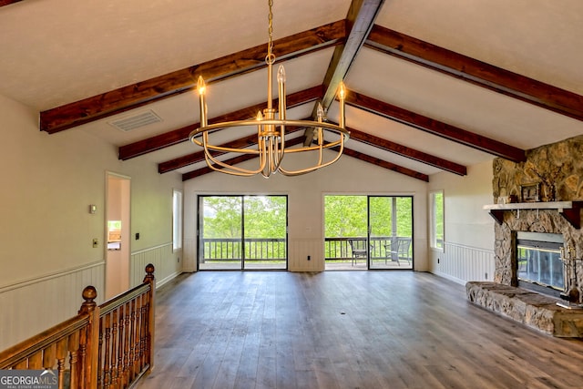 unfurnished living room with an inviting chandelier, vaulted ceiling with beams, a stone fireplace, and wood-type flooring